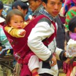 Photo of a man, carrying his child / Fotografija moškega, ki nosi na hrbtu otroka